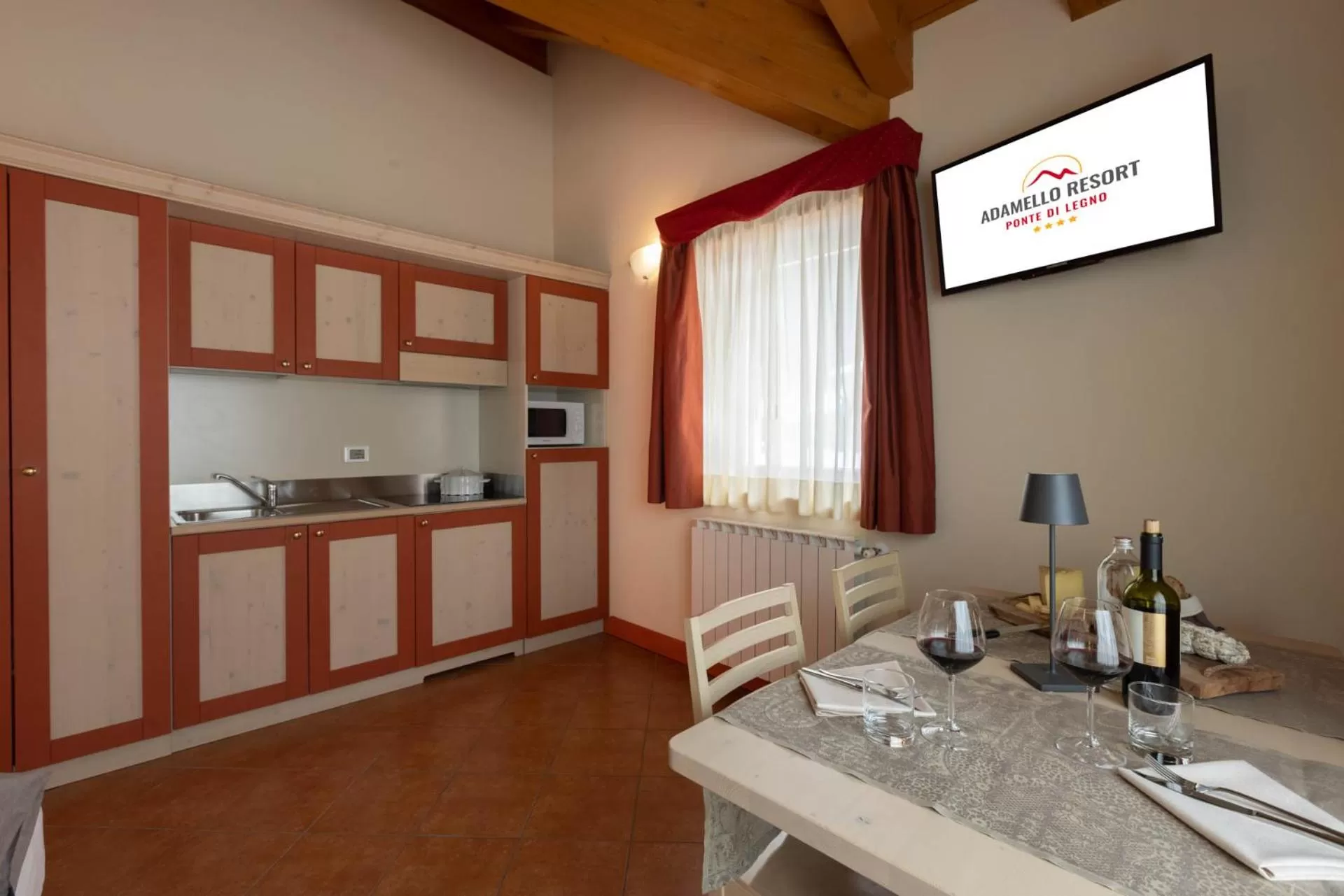 Living room, Kitchen/Kitchenette in Residence Adamello Resort