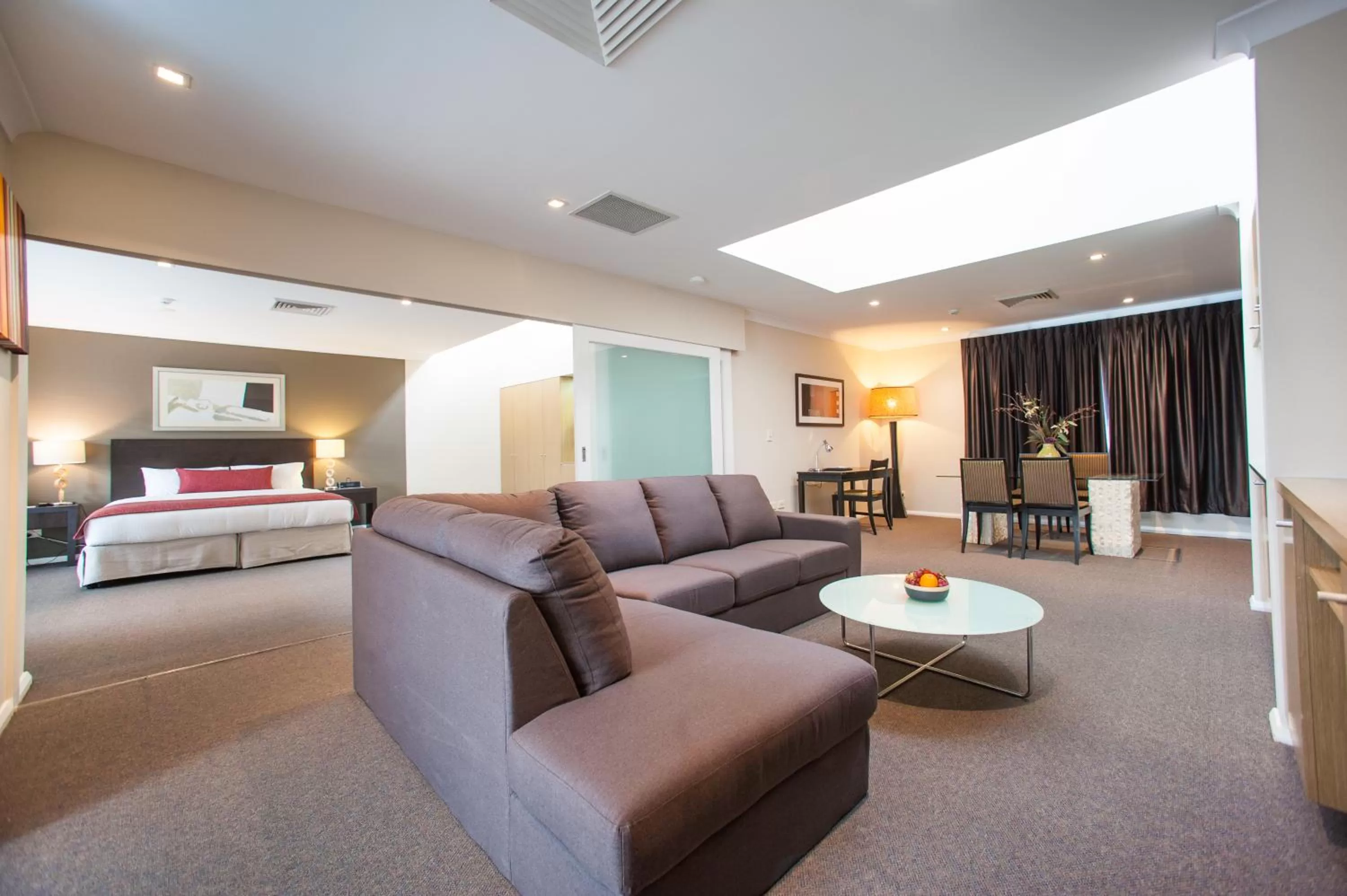Living room, Bed in Ramada Hotel & Suites by Wyndham Cabramatta