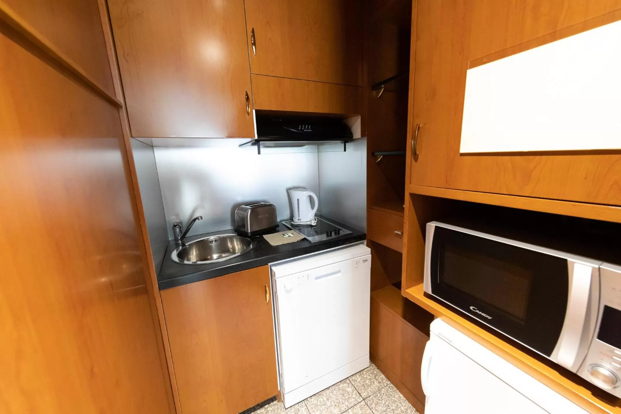Kitchen or kitchenette in Goldstar Apartments & Suites
