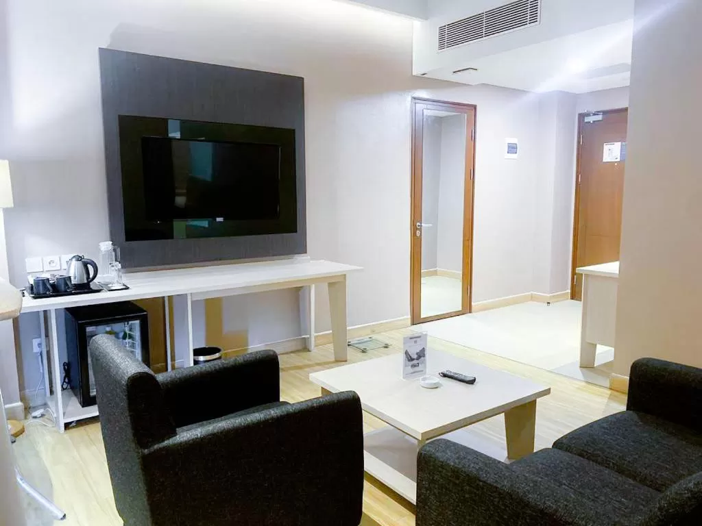 Living room in Harper Palembang by ASTON