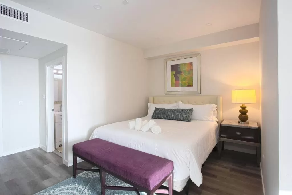 Bed in One Bedroom Apartment with SD Downtown View