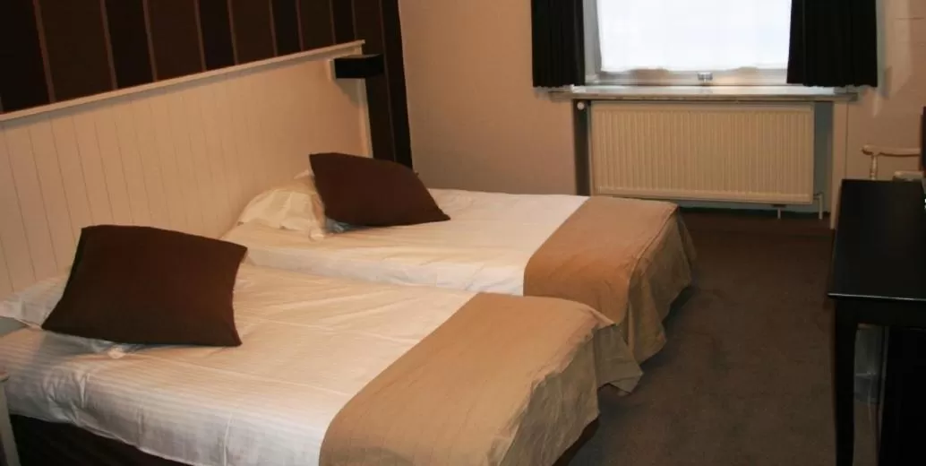 Bed in Hotel Ambassade