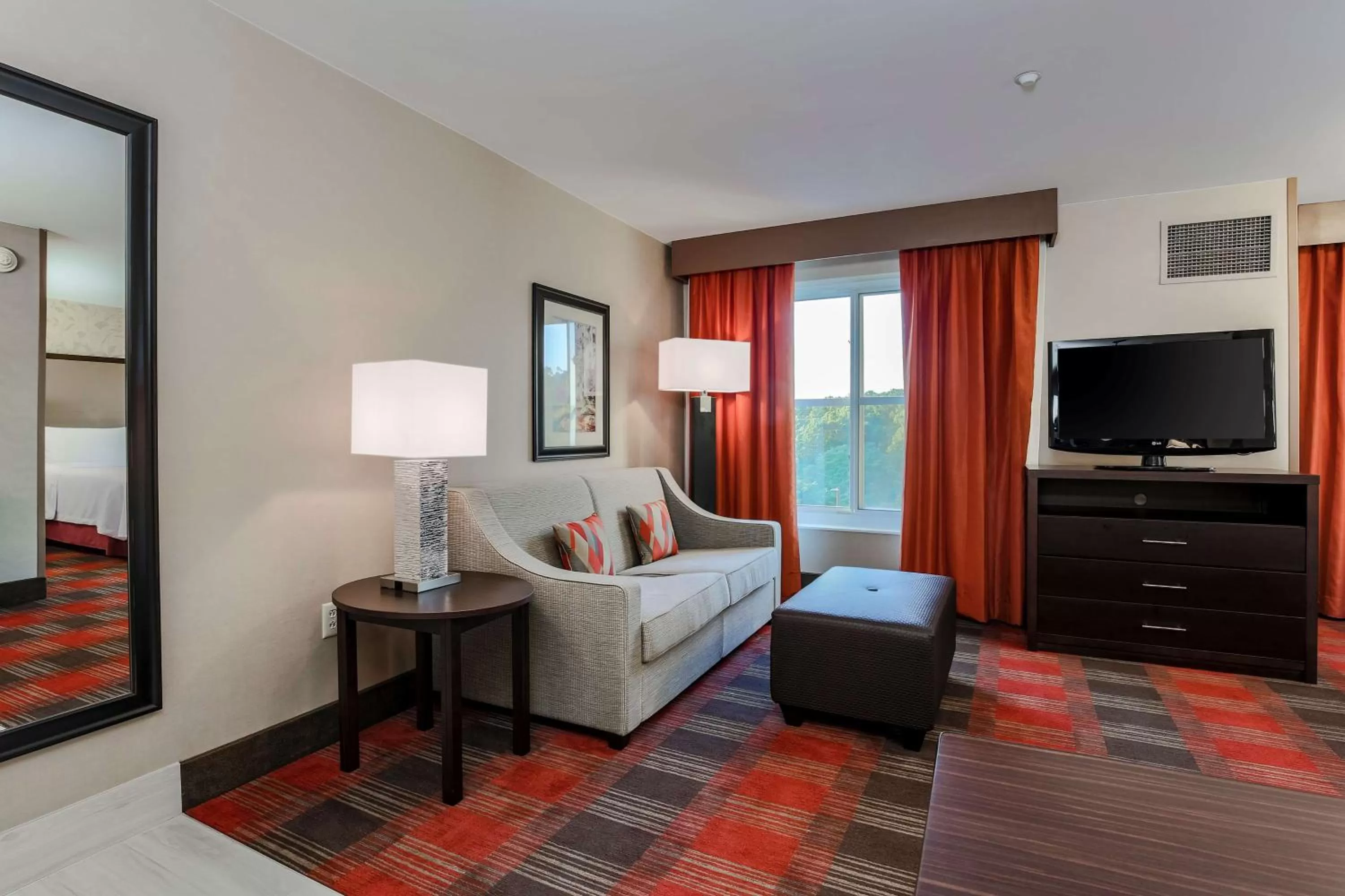 Living room, Bed in Homewood Suites by Hilton Long Island-Melville