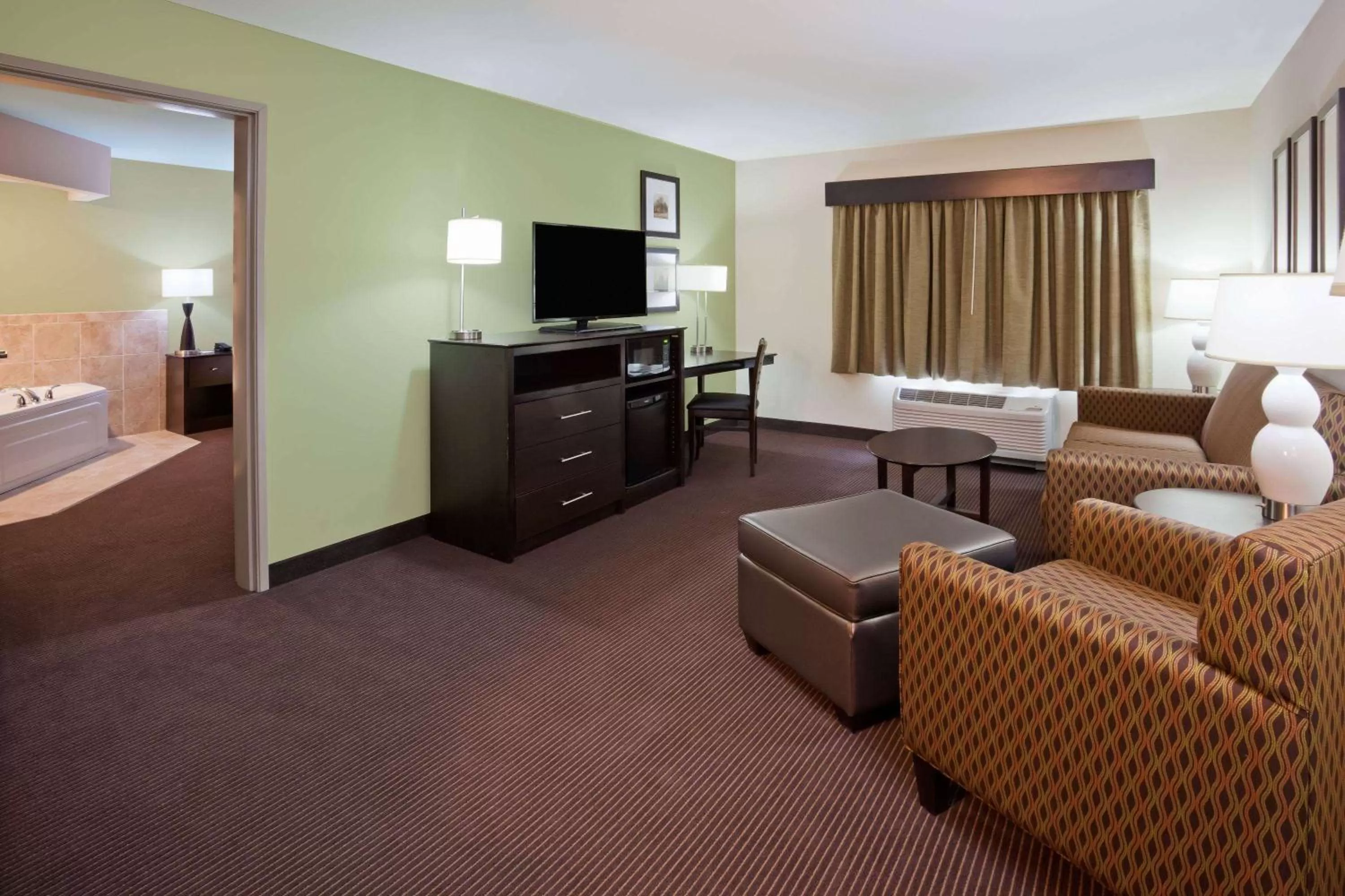 Living room, Bed in AmericInn by Wyndham DeWitt
