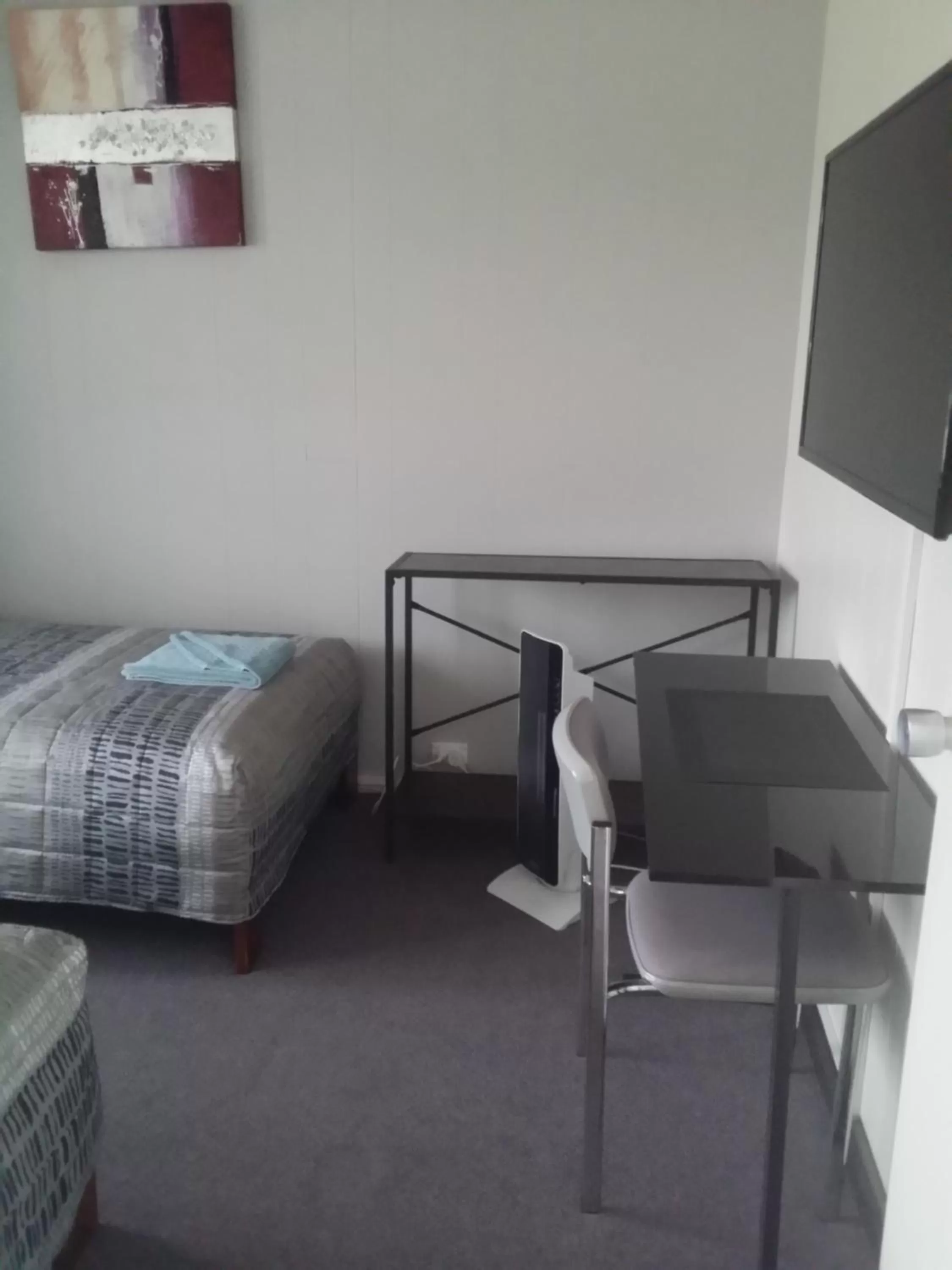 Bed in White Manor Motel