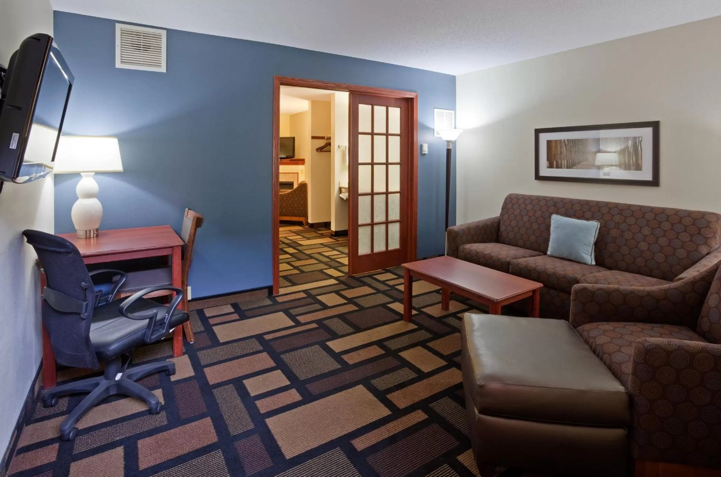 Living room in AmericInn by Wyndham Austin