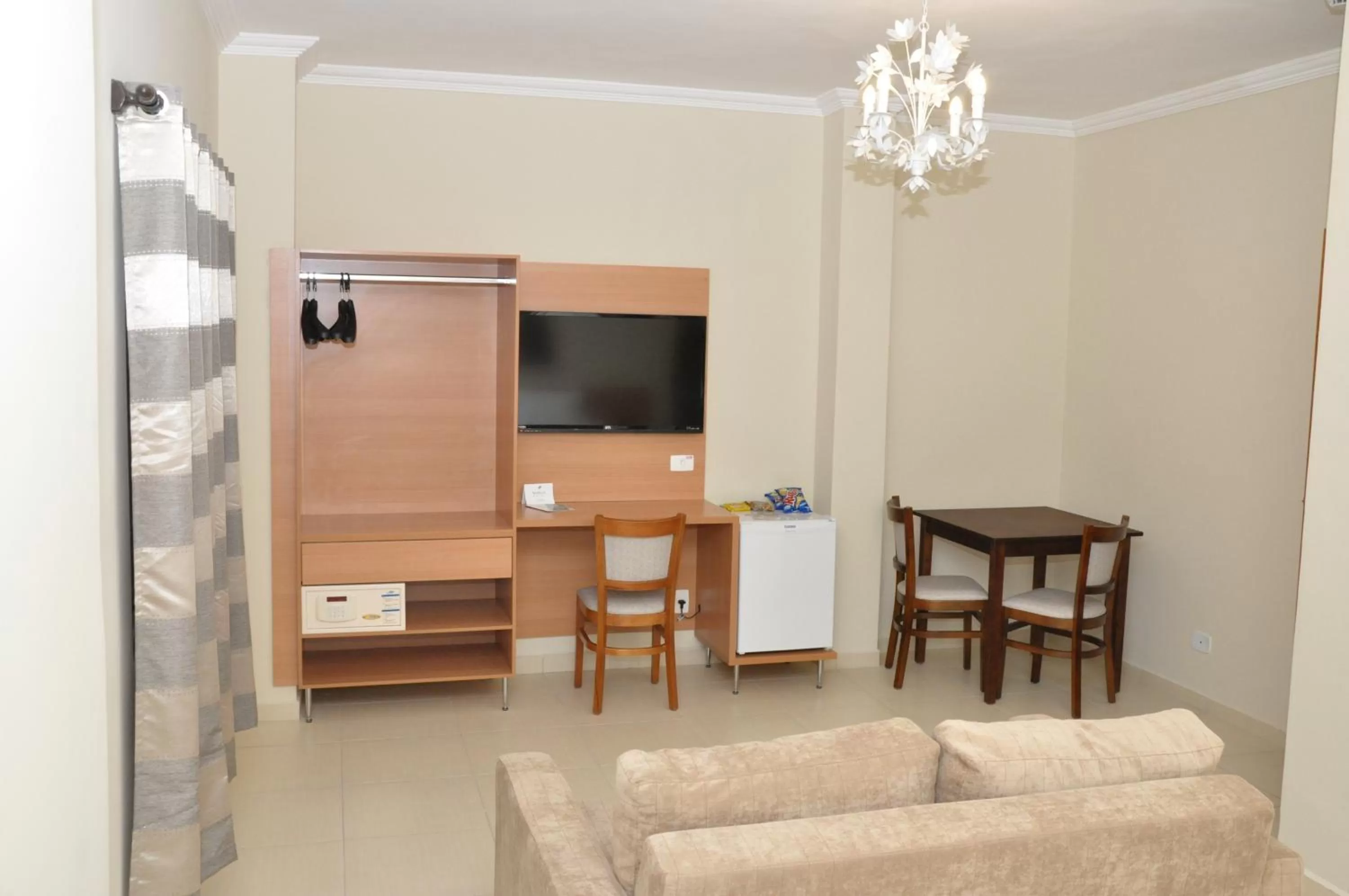 Photo of the whole room, TV/Entertainment Center in Lotus Hotel - à 6 km do Santuário de Aparecida-SP