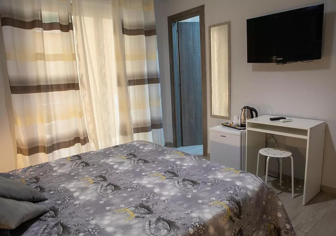 Bed, TV/Entertainment Center in zuroli suite