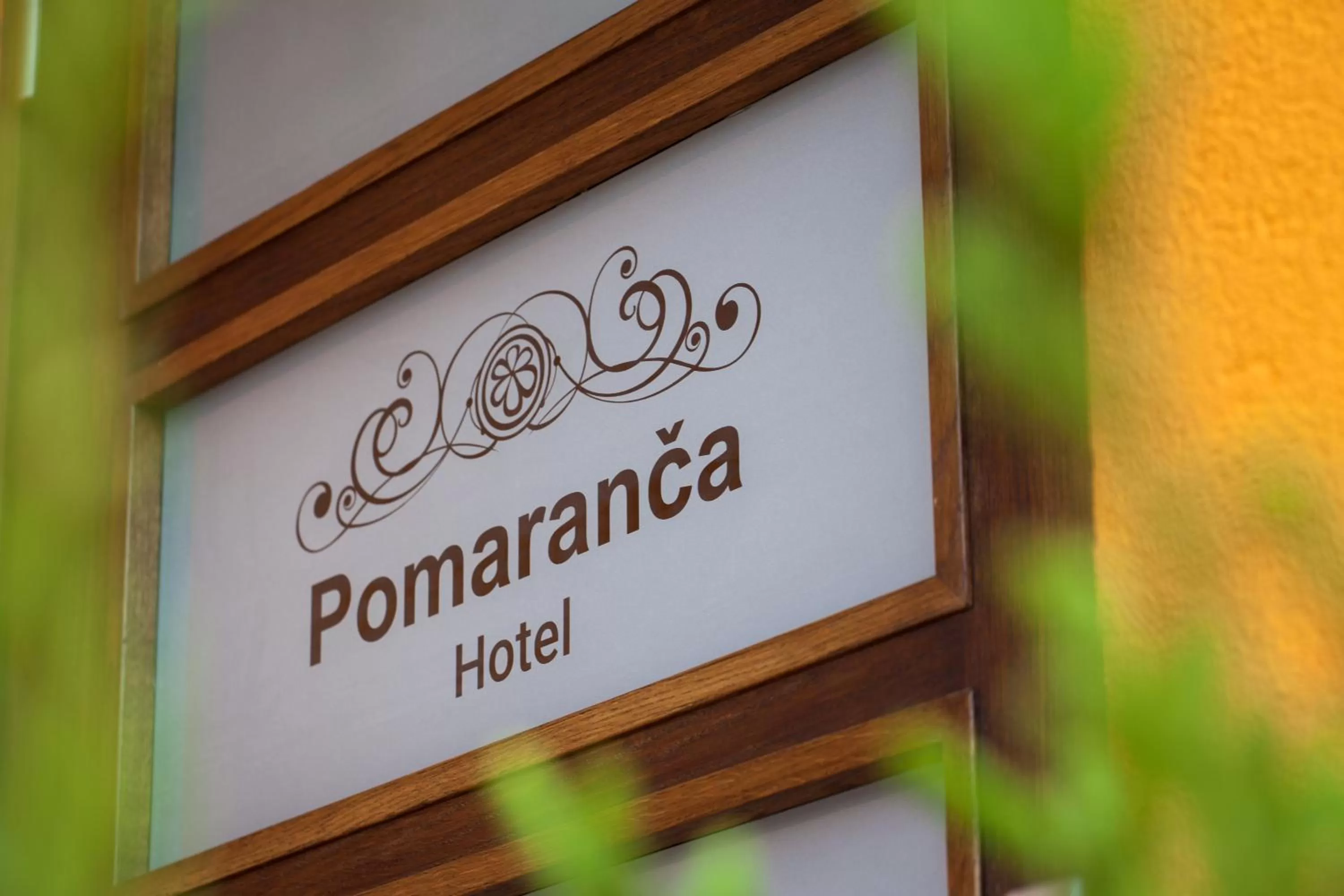 Property logo or sign in Hotel Pomaranča