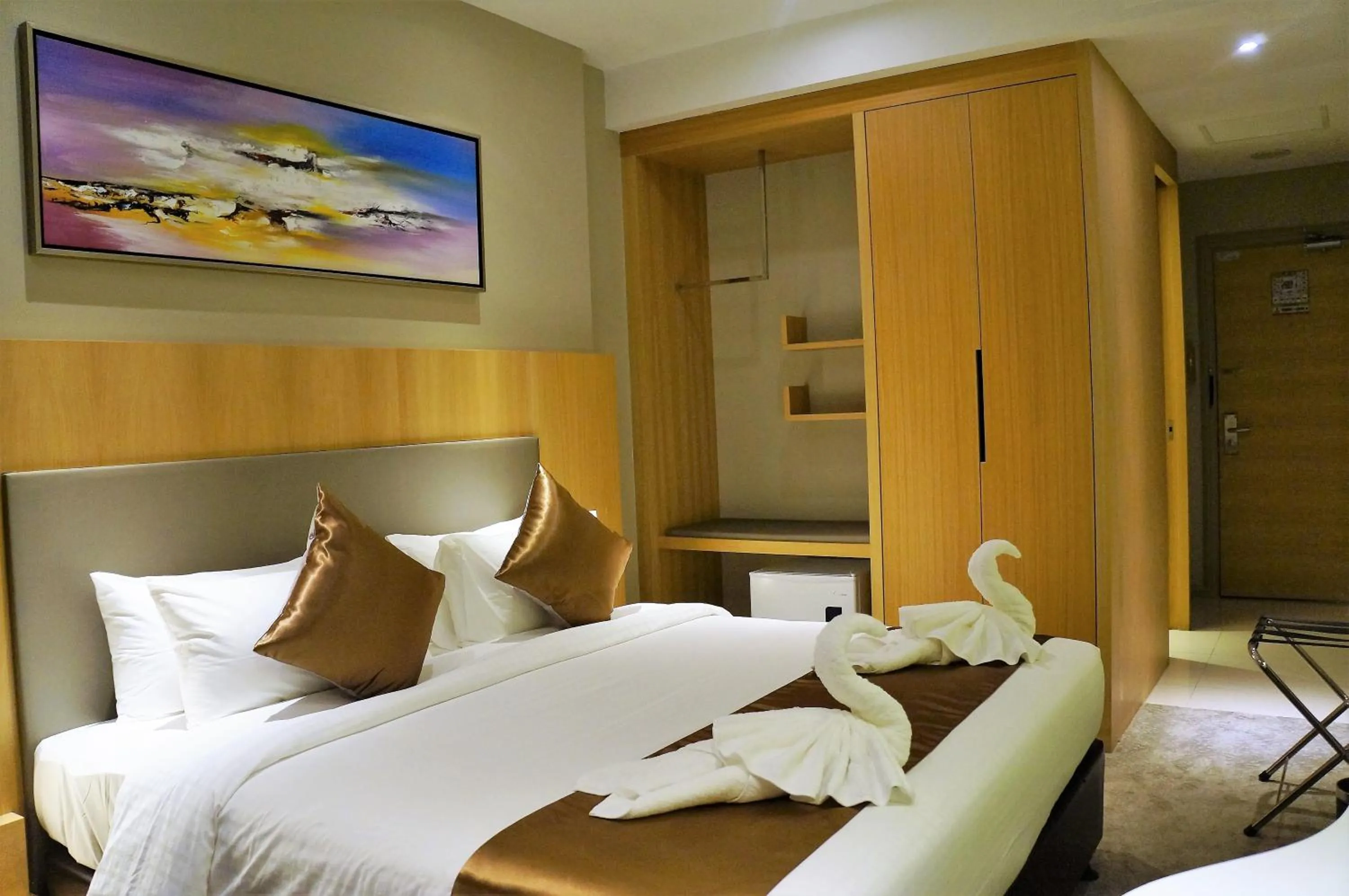 Bed in Greens Hotel & Suites