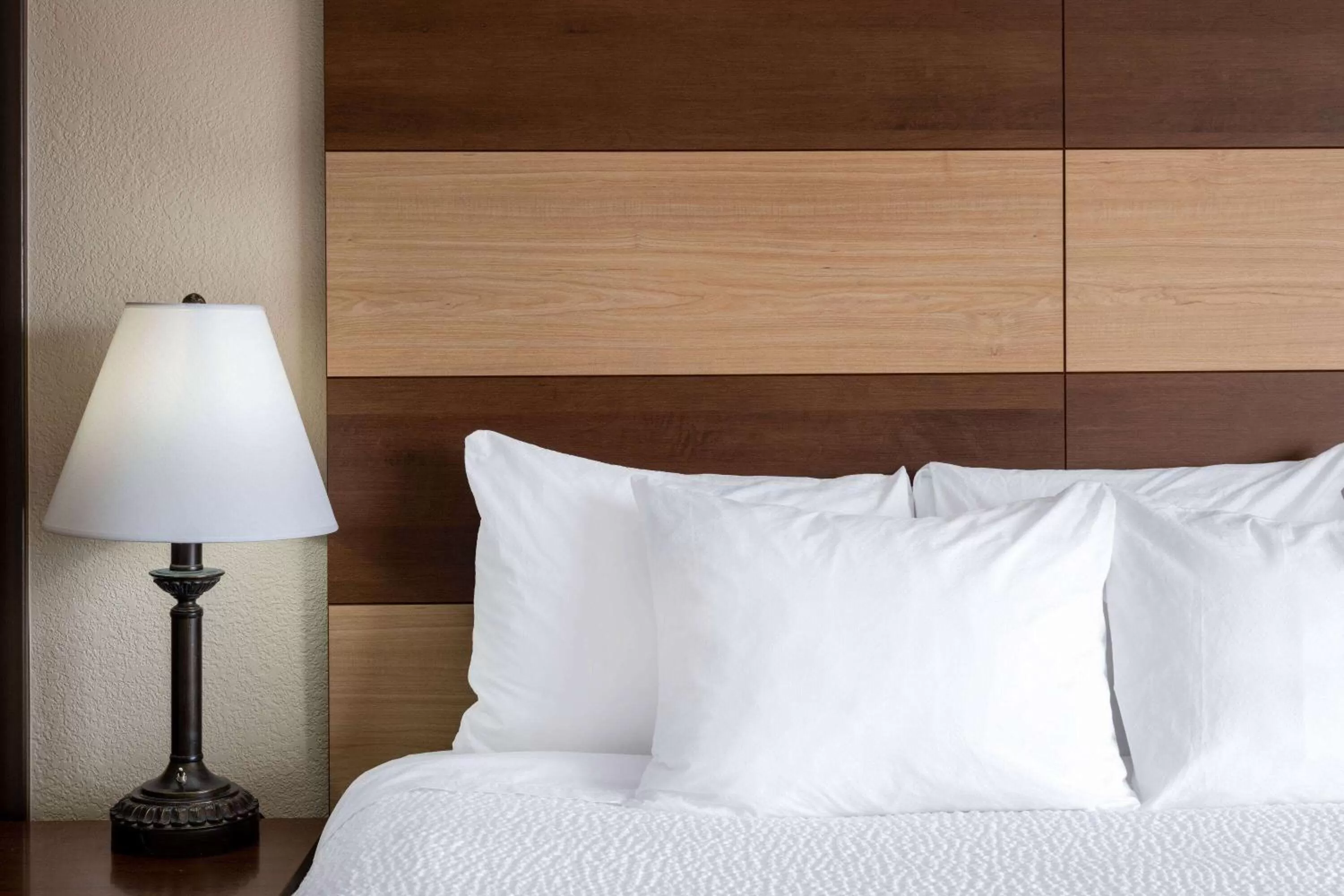 Bed in AmericInn by Wyndham Cedar Rapids North