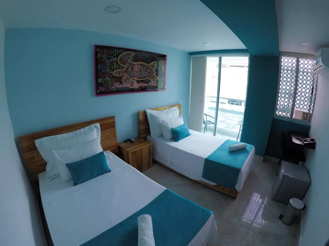 Bed in Kamaleb Farallones Hotel