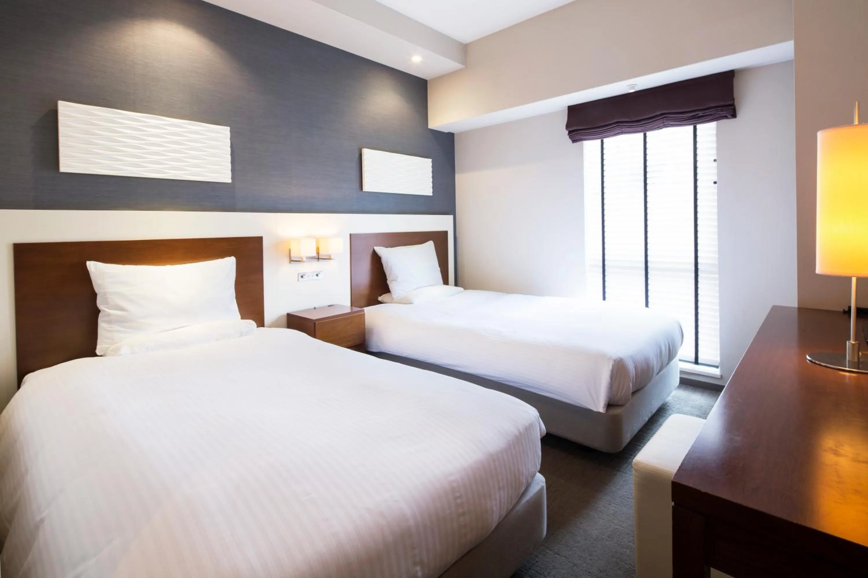 Bed in HOTEL MYSTAYS Oita