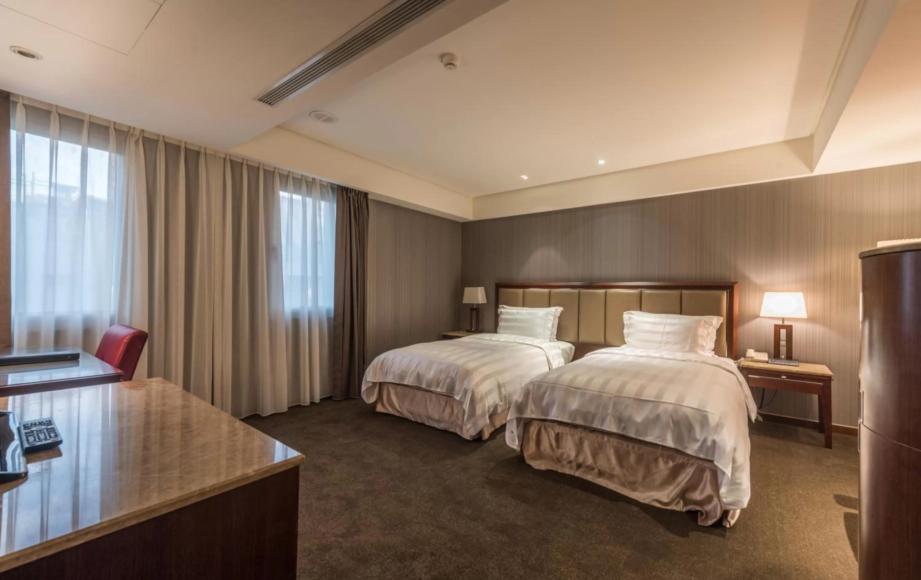 Bed in Royal Biz Taipei Hotel