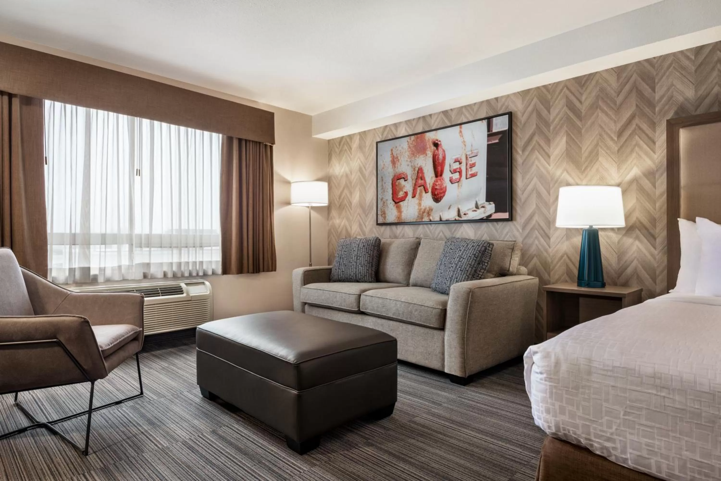 Seating area, Bed in Ramada by Wyndham Airdrie Hotel & Suites