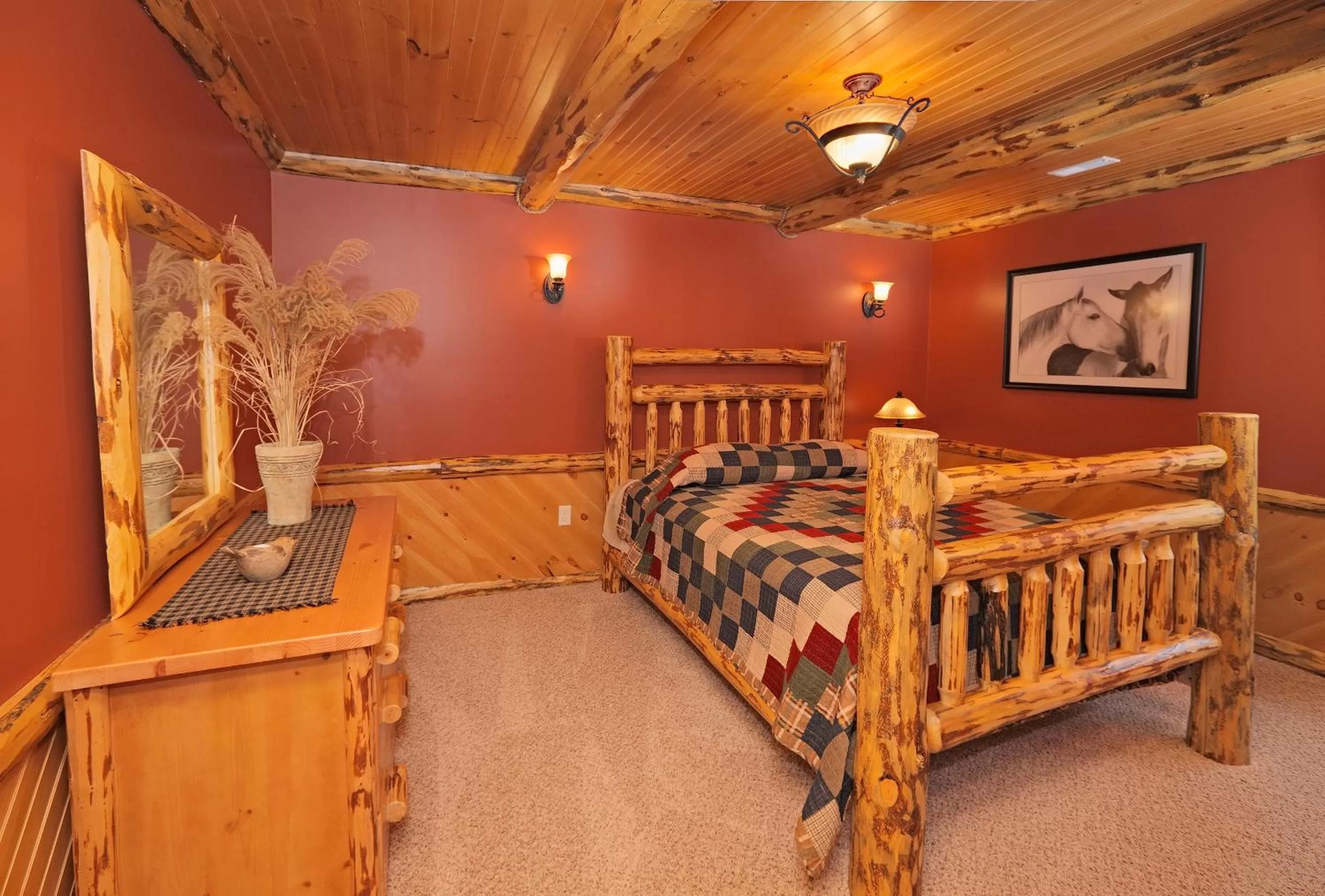 Bed in Sojourner's Lodge & Log Cabin Suites