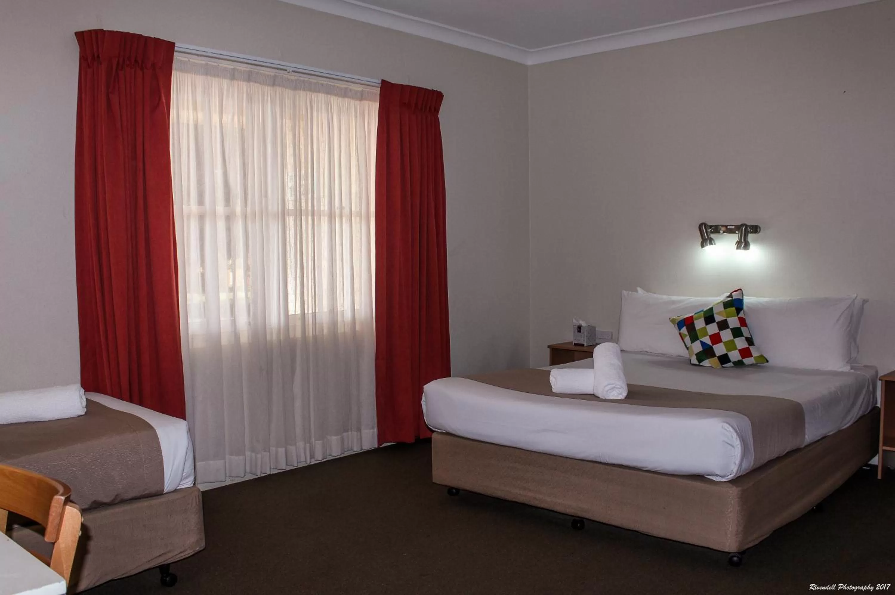 Downstairs Room with a Queen and 3 Single Beds in Motel Riverina