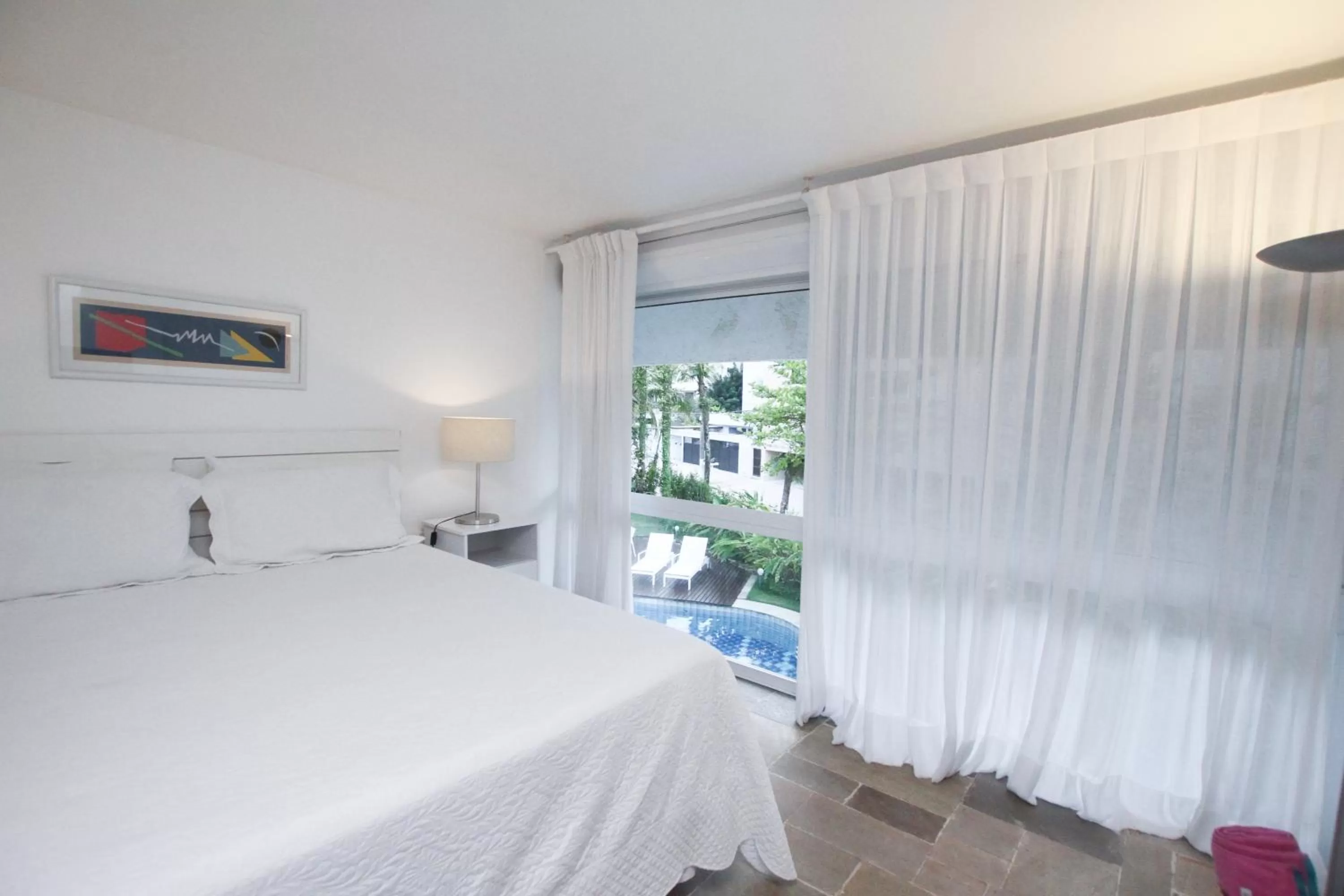 Bed in Guest House Guarujá