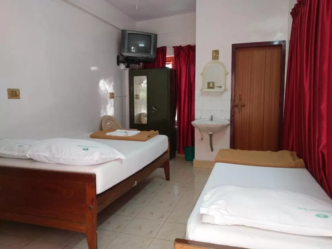 Bed in Anandan Tourist Home