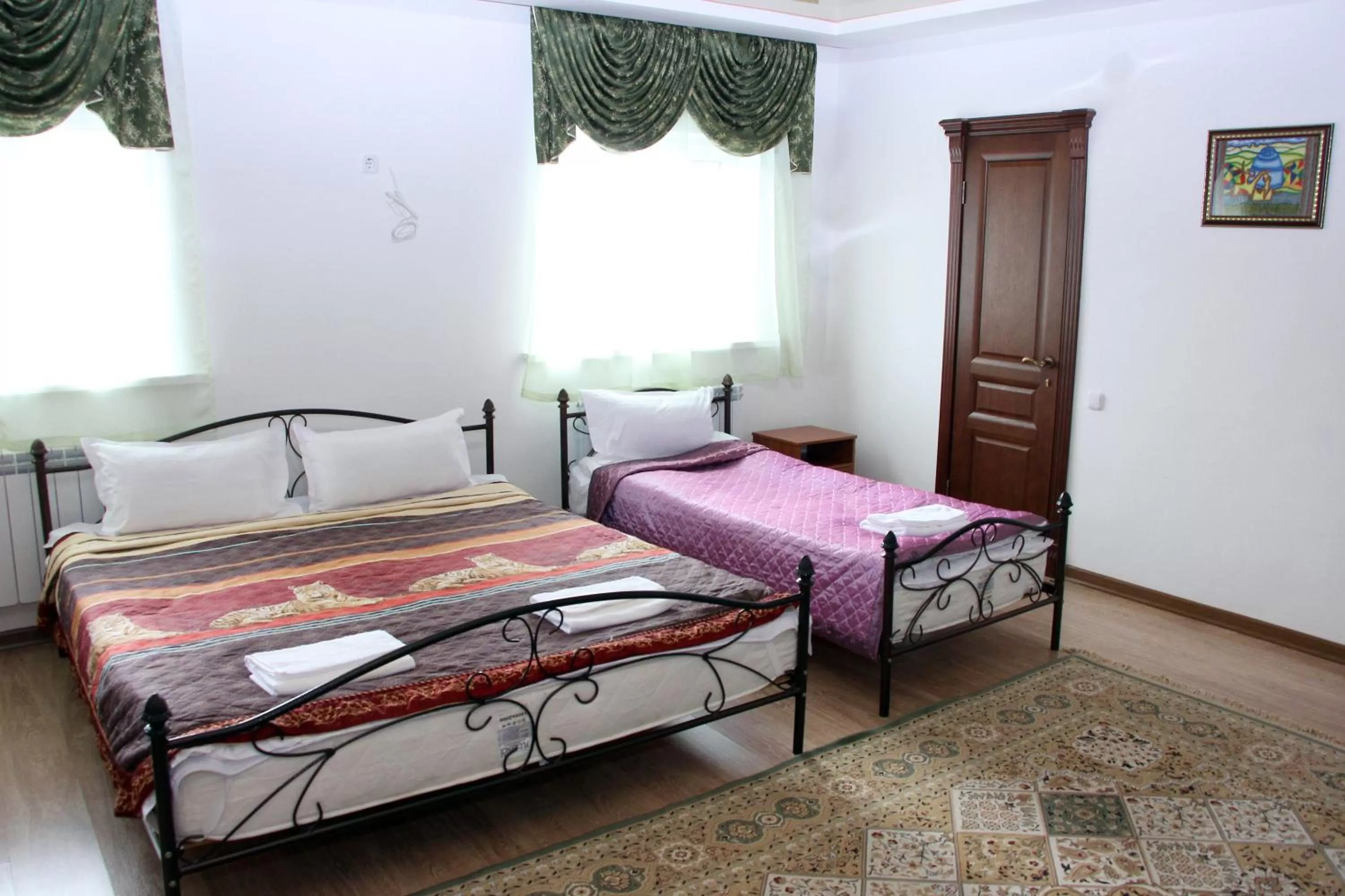 Bed in Zhaylau Hotel