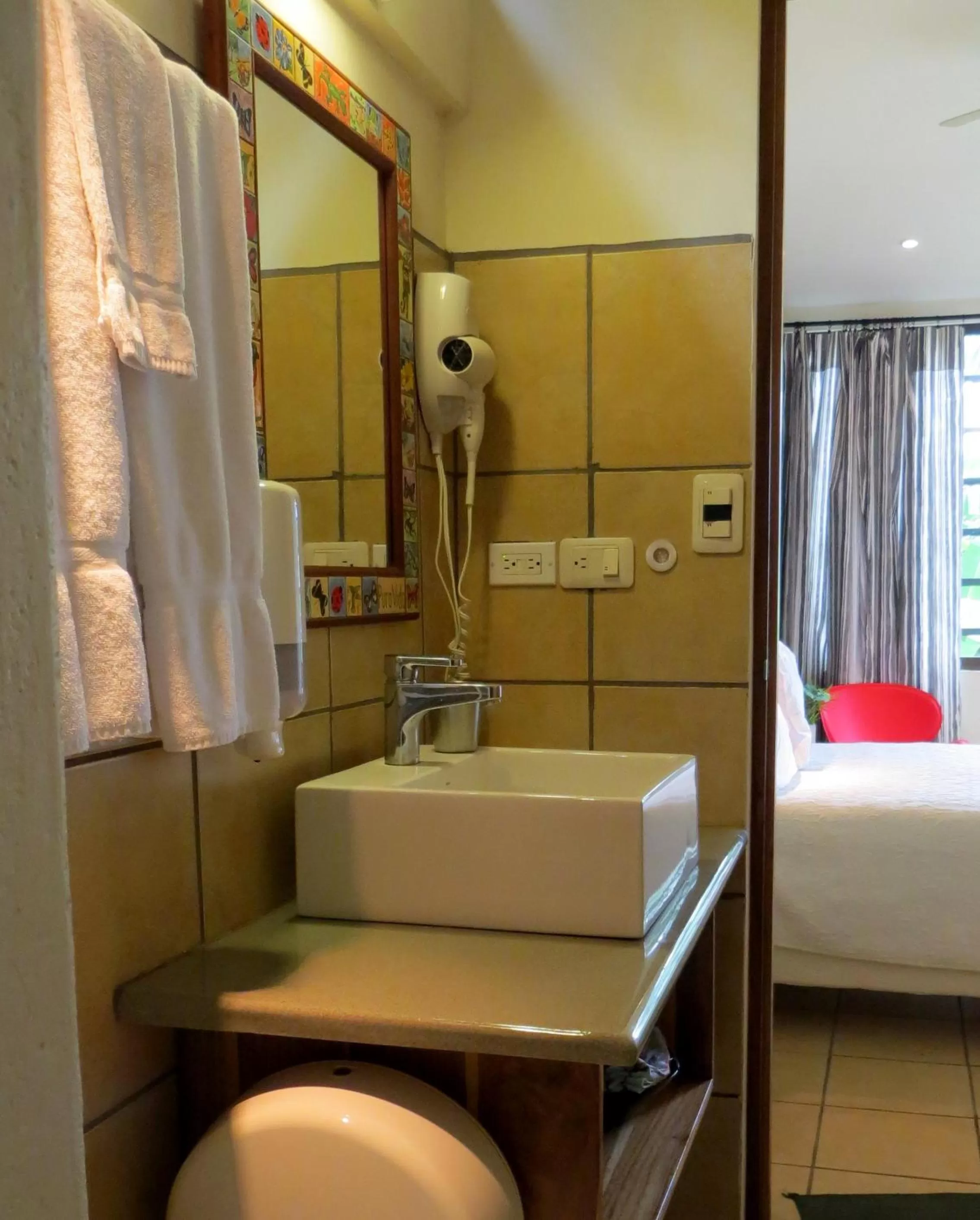 Bathroom, Bed in Pura Vida Hotel