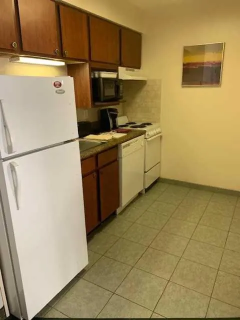 Kitchen or kitchenette in Host Inn an All Suites Hotel
