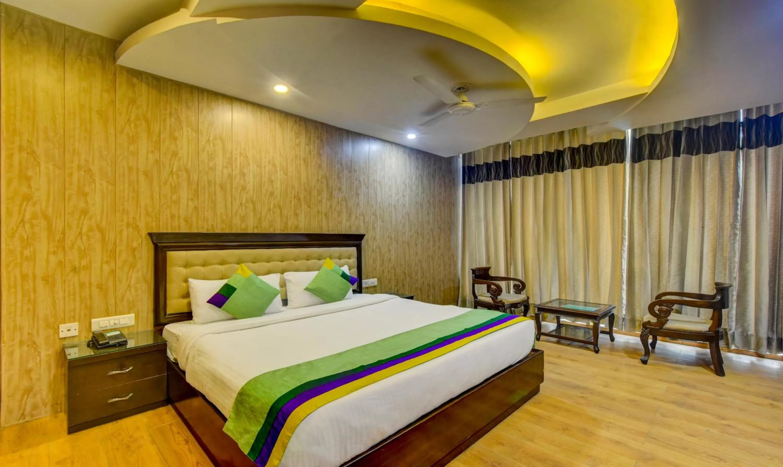 Seating area, Bed in Treebo Elysee, Patel Nagar