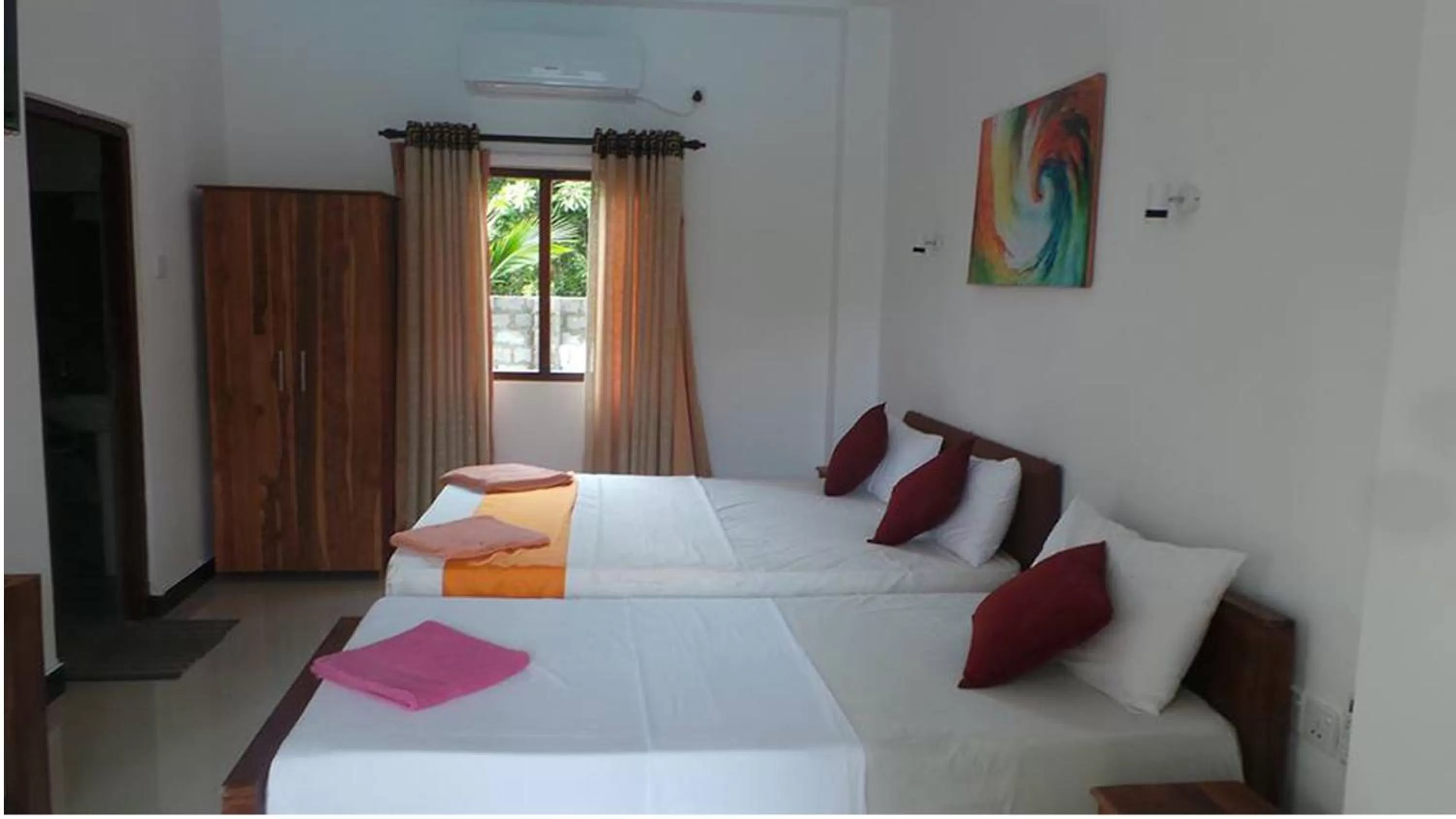 Bed in WindMill Beach Villa and Hotel