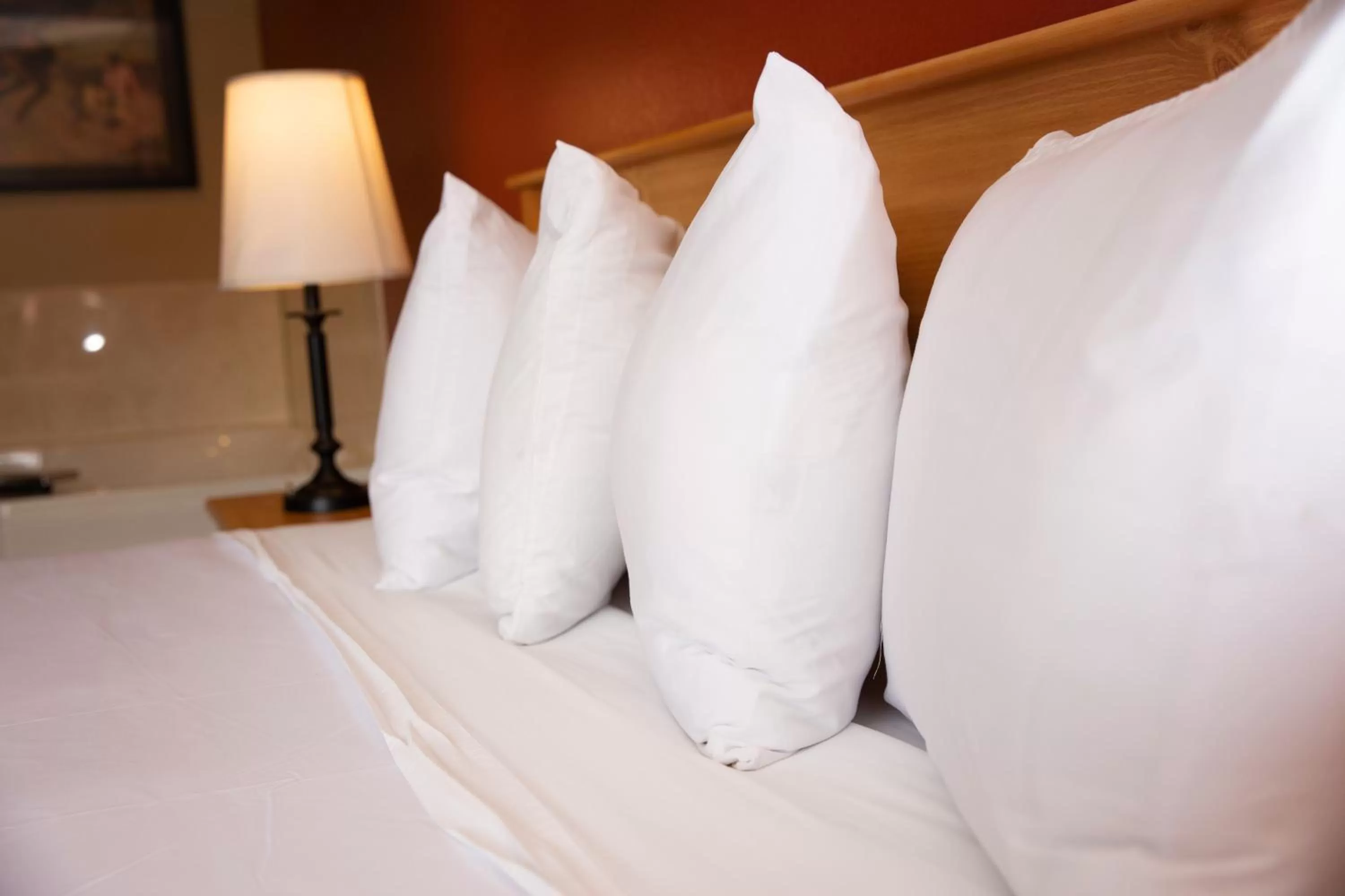 Bed in AmericInn by Wyndham Pampa Event Center