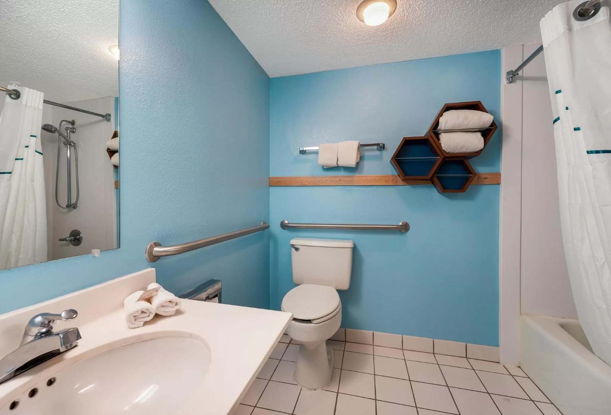 Bathroom in HomeTowne Studios by Red Roof Painted Post