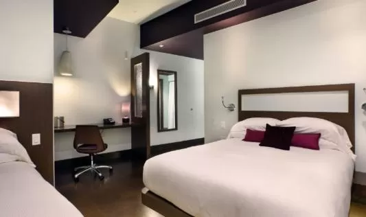 Bed in CityFlatsHotel - Grand Rapids, an Ascend Collection Hotel