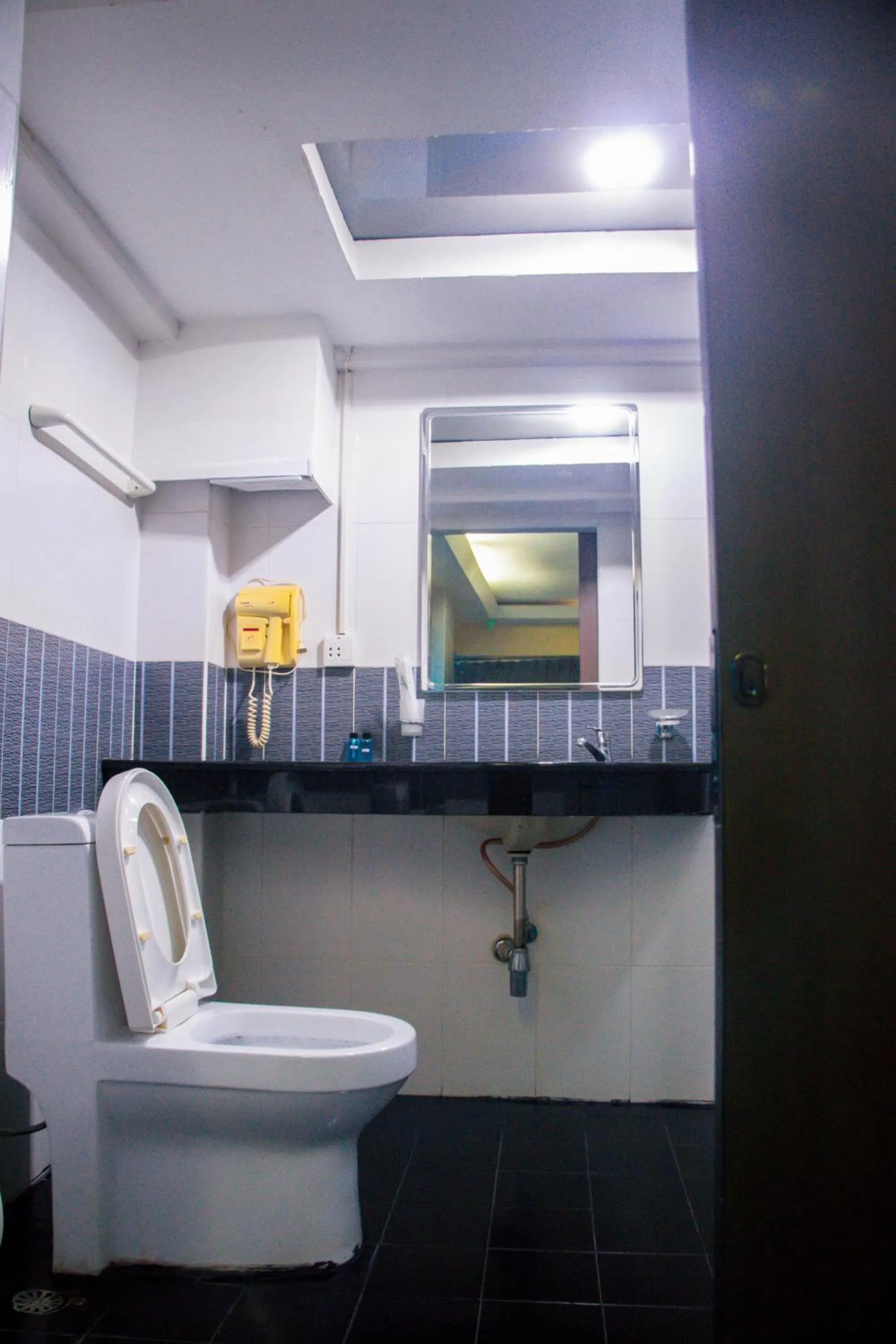Toilet in Visiting Card Hotel & Resort