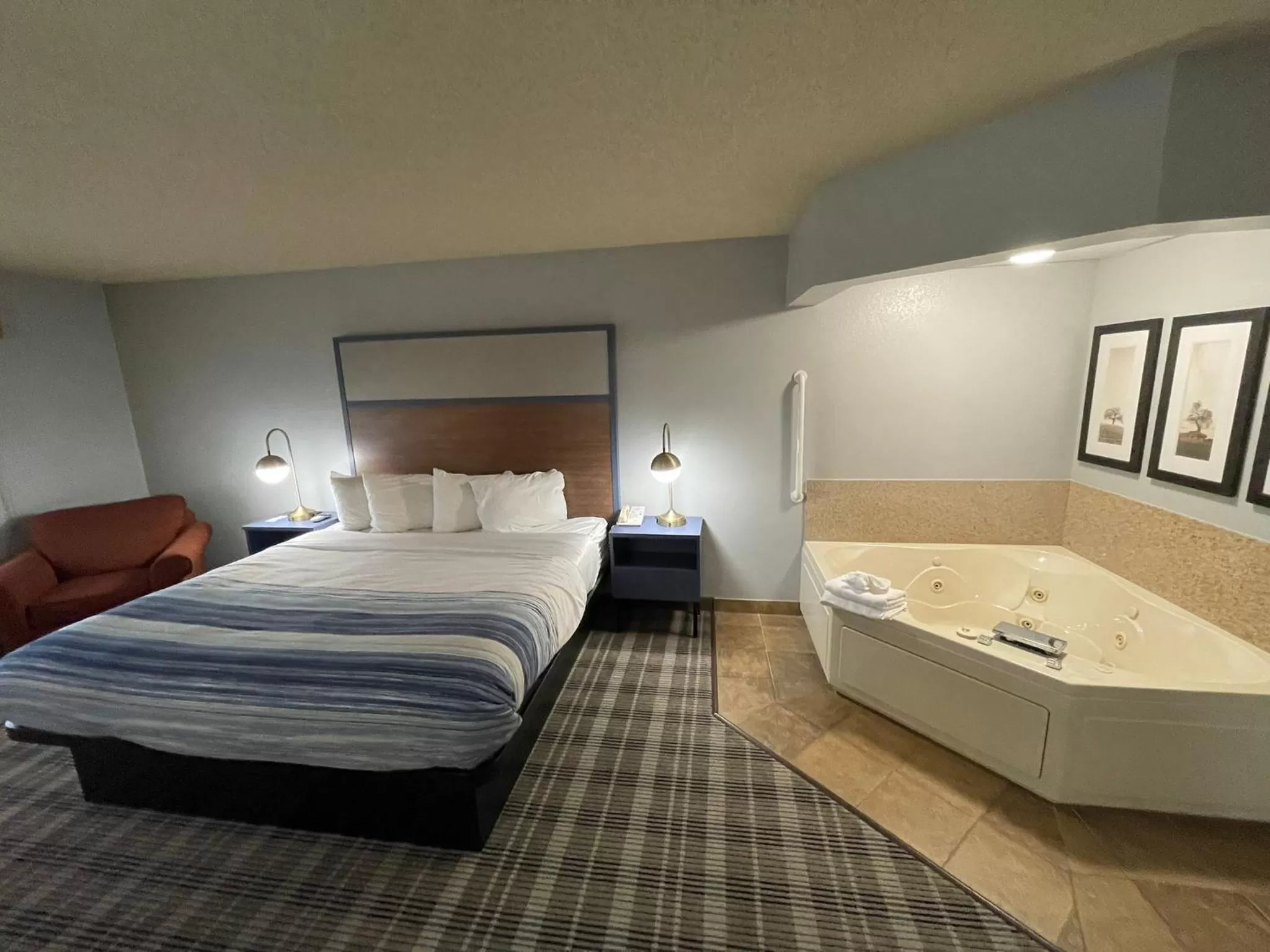 Bed in AmericInn by Wyndham Sayre