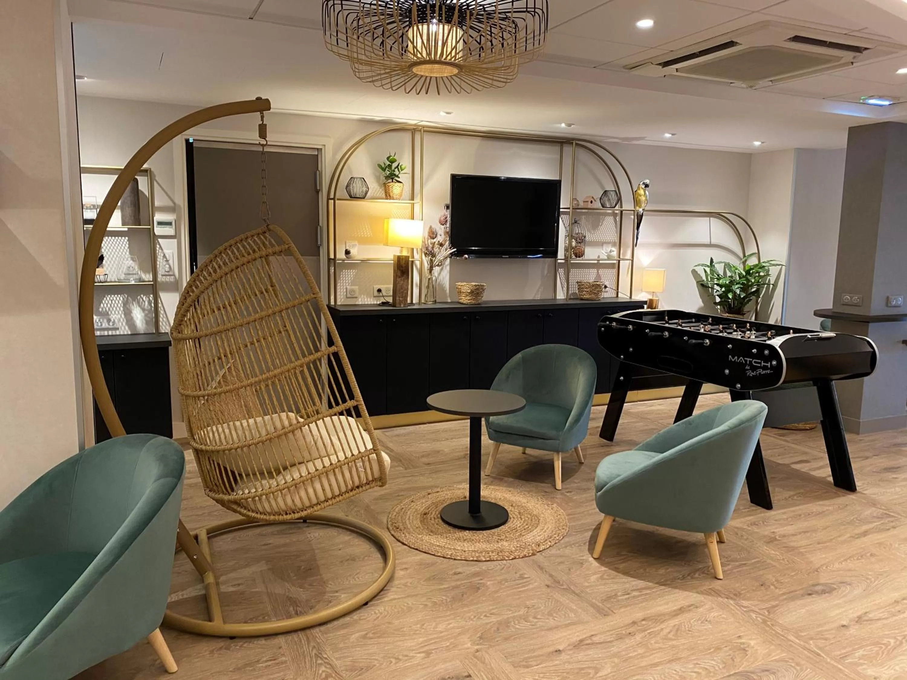 Communal lounge/ TV room in ibis Styles Rennes Cesson