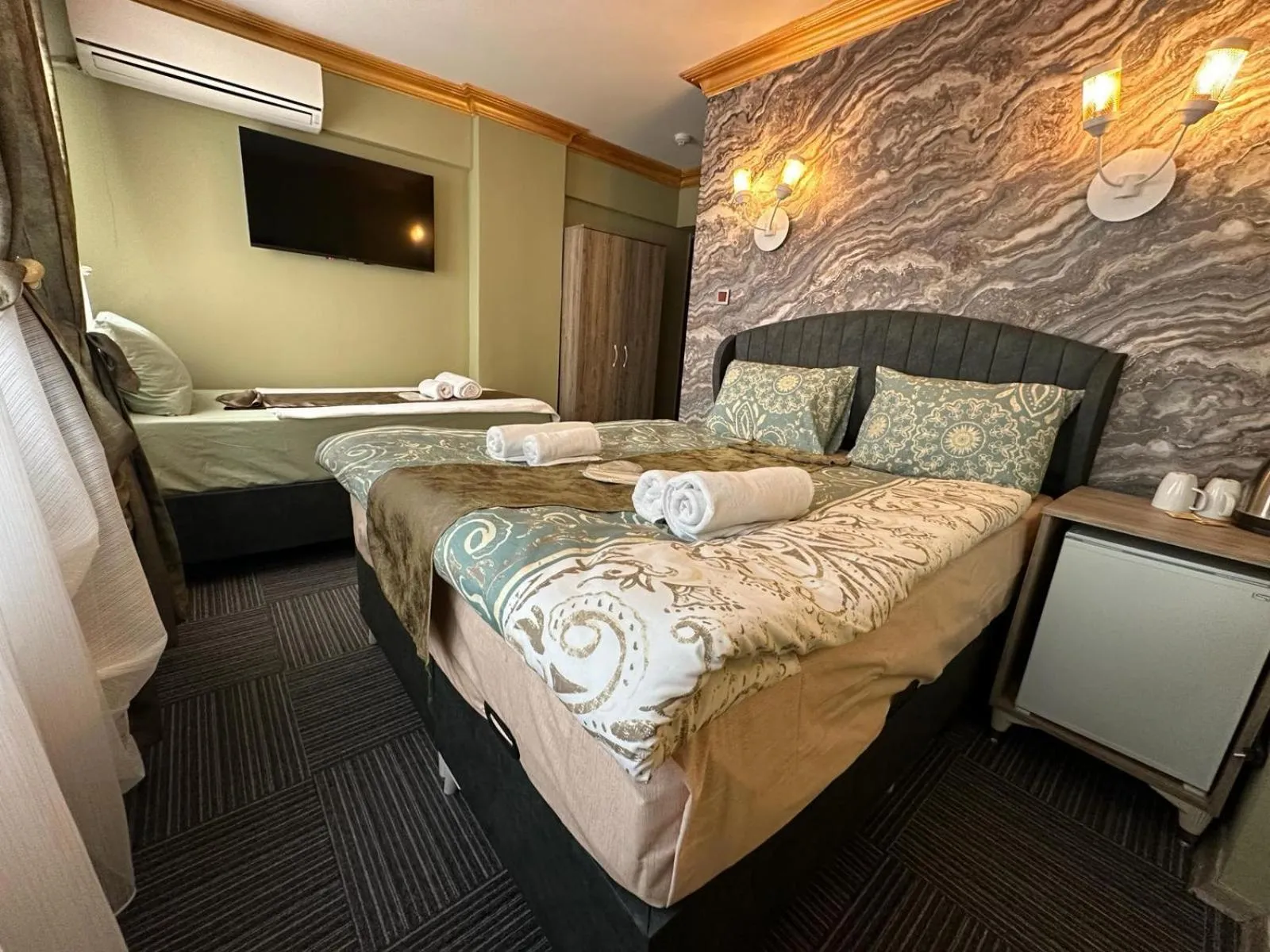 Bed in Royal Gur Hotel