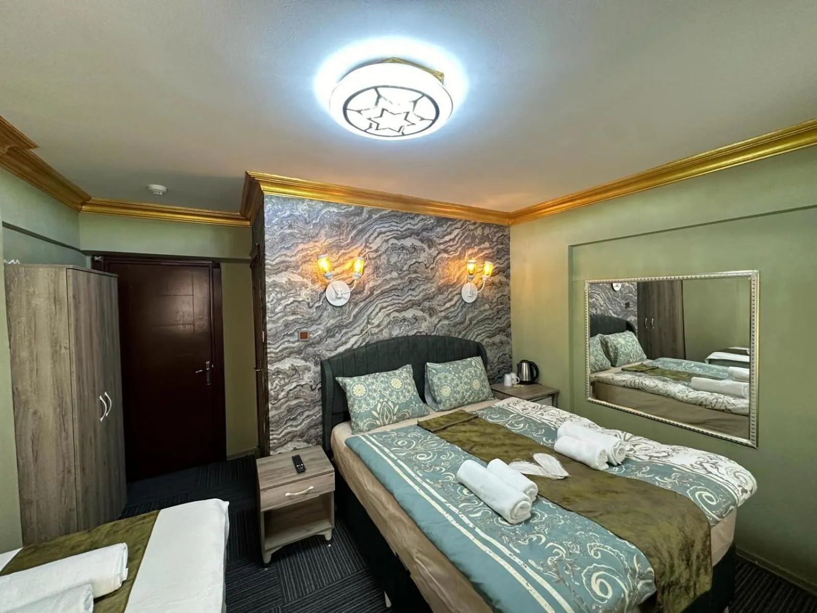 Bed in Royal Gur Hotel