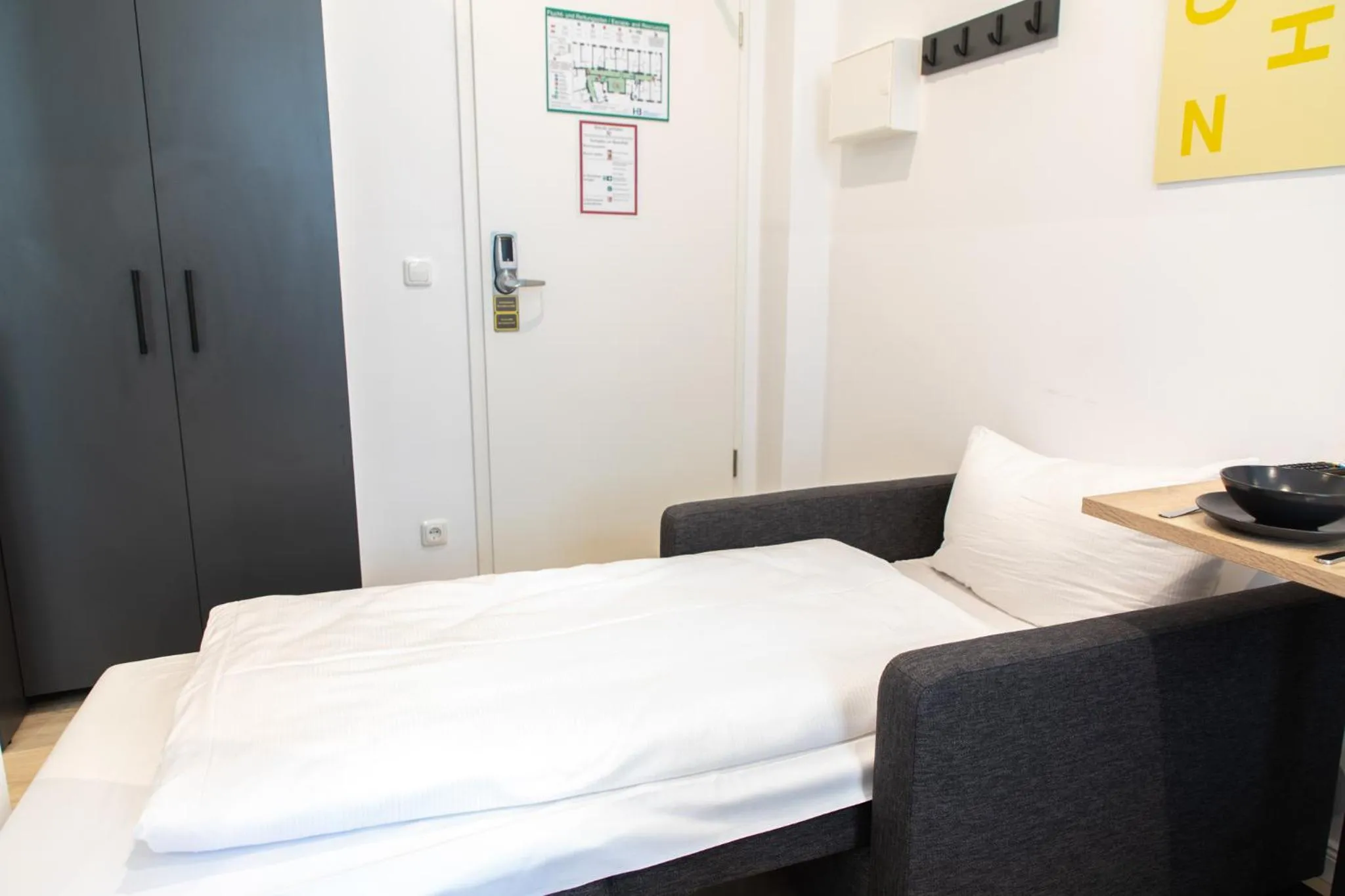 Bed in Servus Apartments by Homaris