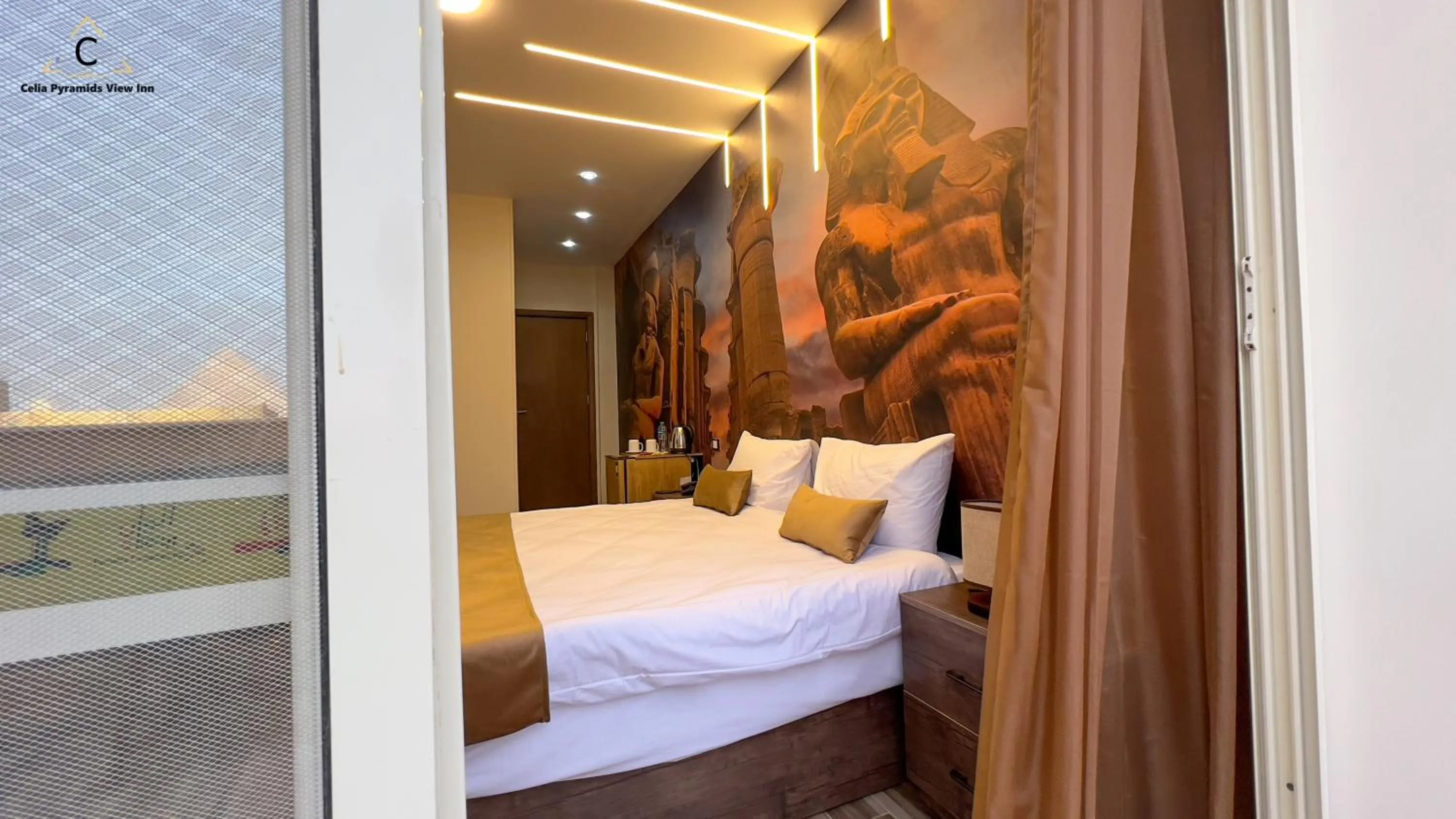 Bed in Celia Pyramids View inn