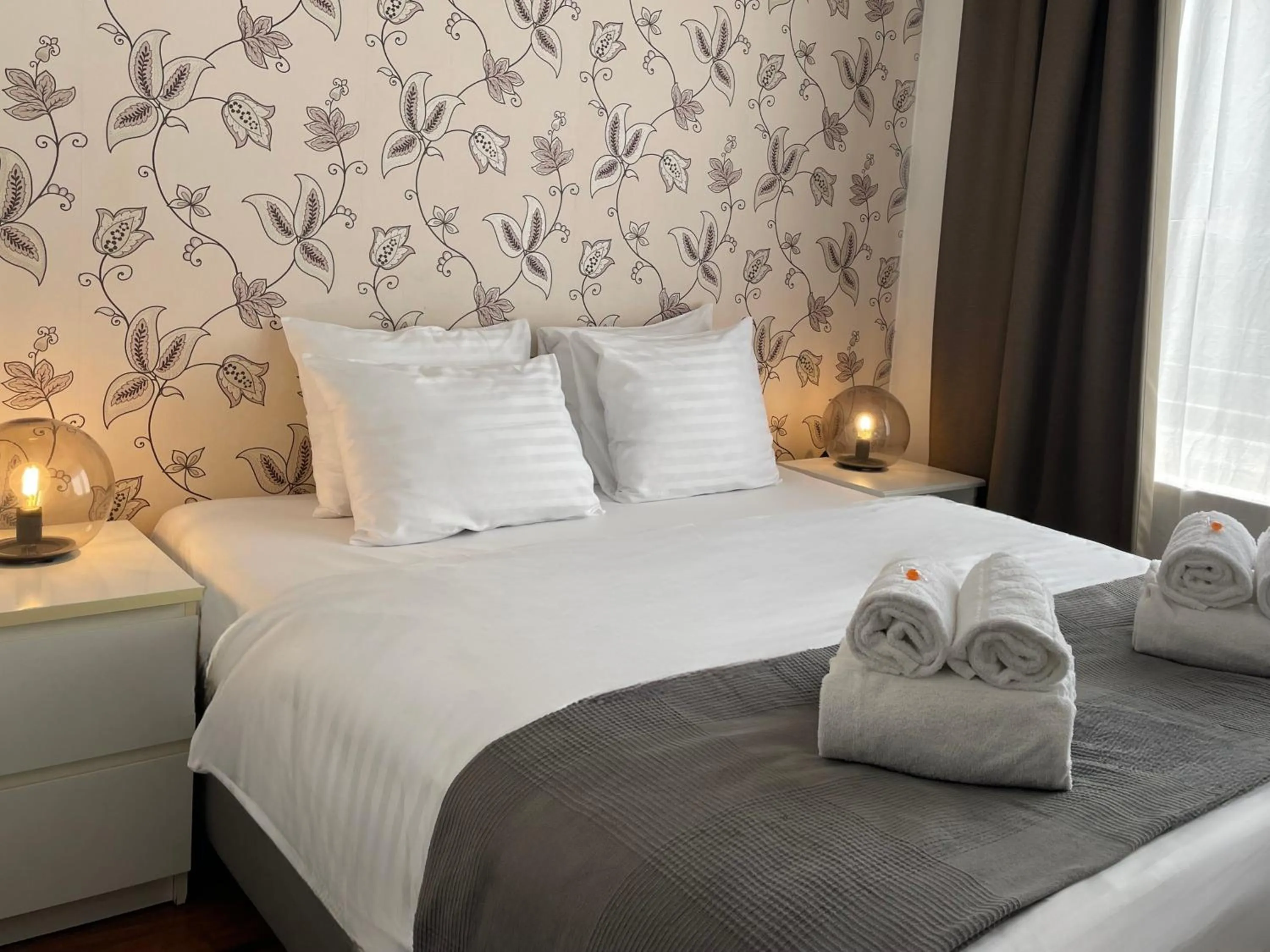 Bed in Corvin Center Suites