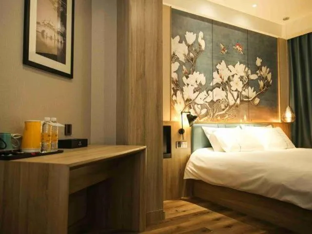 Bed in Magnolia Business Hotel Yangzhou Wanda Plaza Shunda Road