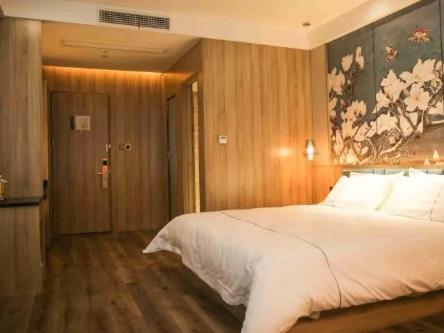 Bed in Magnolia Business Hotel Yangzhou Wanda Plaza Shunda Road