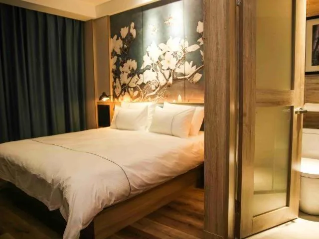 Bed in Magnolia Business Hotel Yangzhou Wanda Plaza Shunda Road