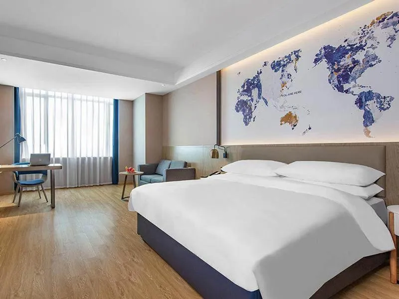 Bed in Kyriad Marvelous Hotel Huizhou Boluo Yuanzhou