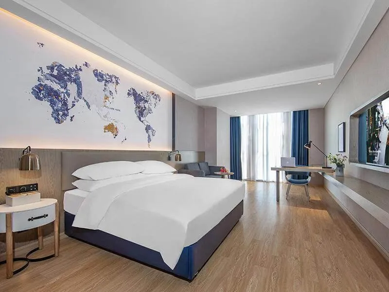Bed in Kyriad Marvelous Hotel Huizhou Boluo Yuanzhou