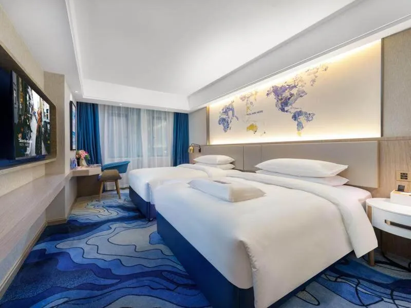 Bed in Kyriad Marvelous Hotel Heyuan Longchuan