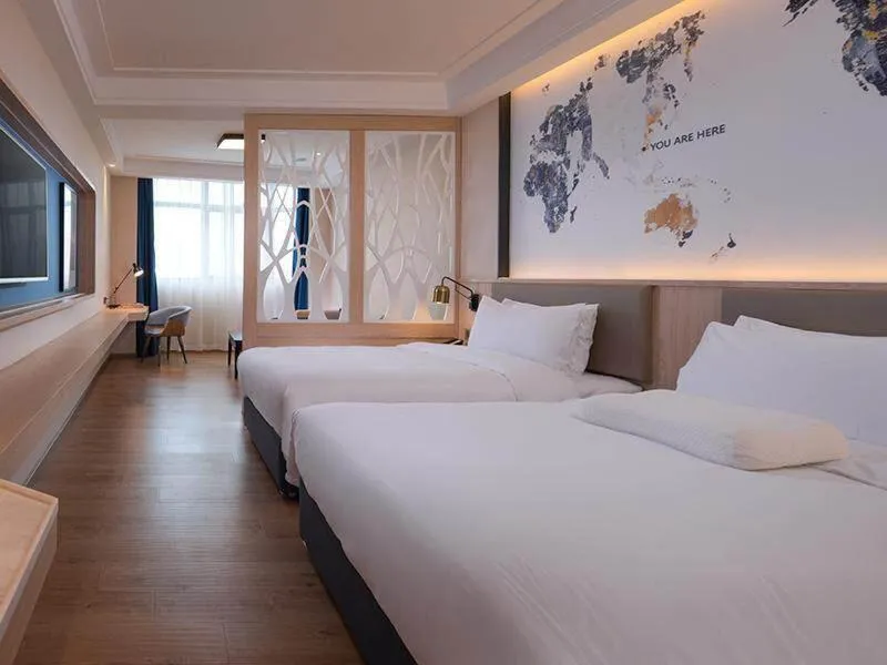 Bed in Kyriad Marvelous Hotel Heyuan Wanlong City