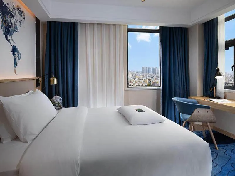 Bed in Kyriad Marvelous Hotel Maoming Dianbai Wanda Plaza