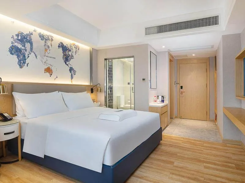 Bed in Kyriad Marvelous Hotel Dongguan Changan Light Rail Station