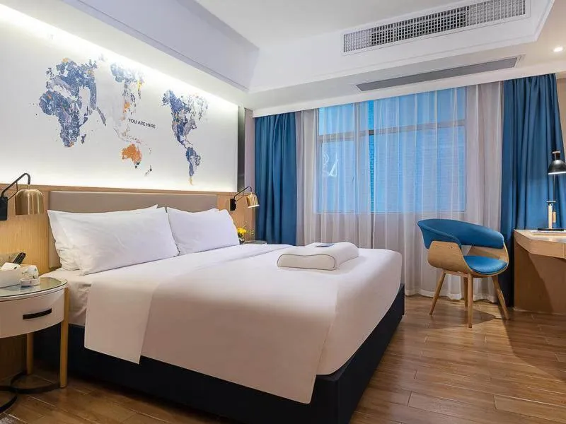 Bed in Kyriad Marvelous Hotel Dongguan Changan Light Rail Station