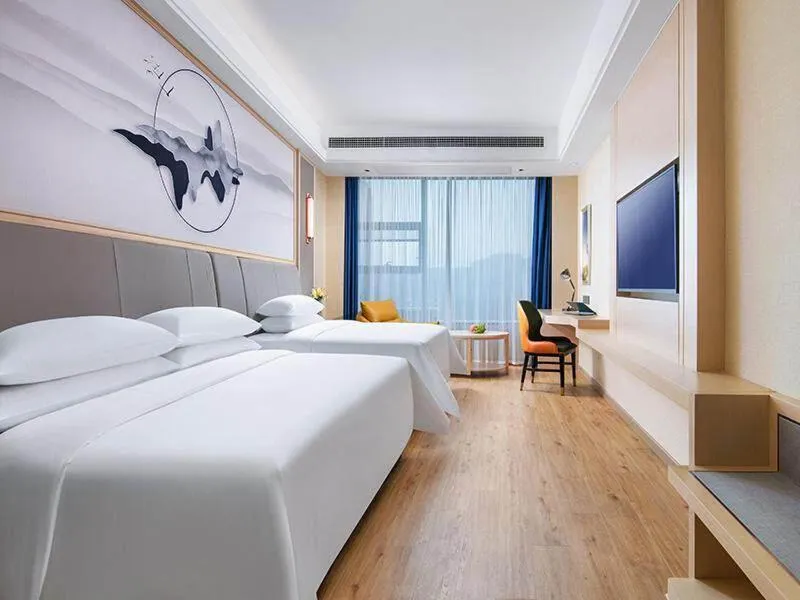 Bed in Vienna International Hotel Jiangsu Wuxi Jiangyin Sports Center